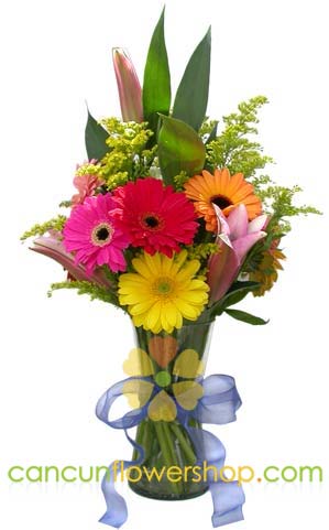 Gerber daisies and lilies in a glass vase